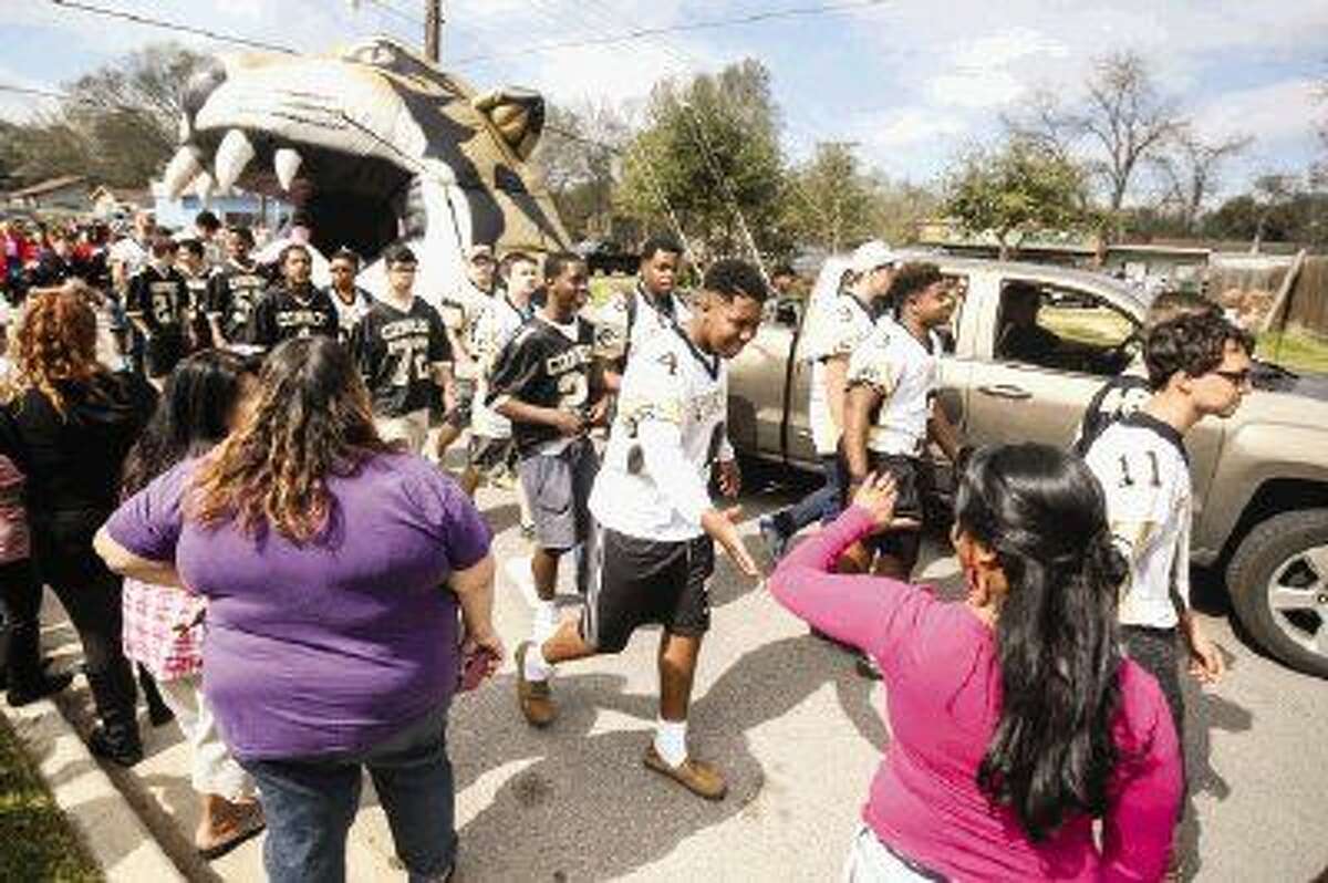 Conroe High School football players march in the Black History Month Parade on Saturday in Conroe. To view more photos from the parade and award ceremony, go to HCNPics.com.