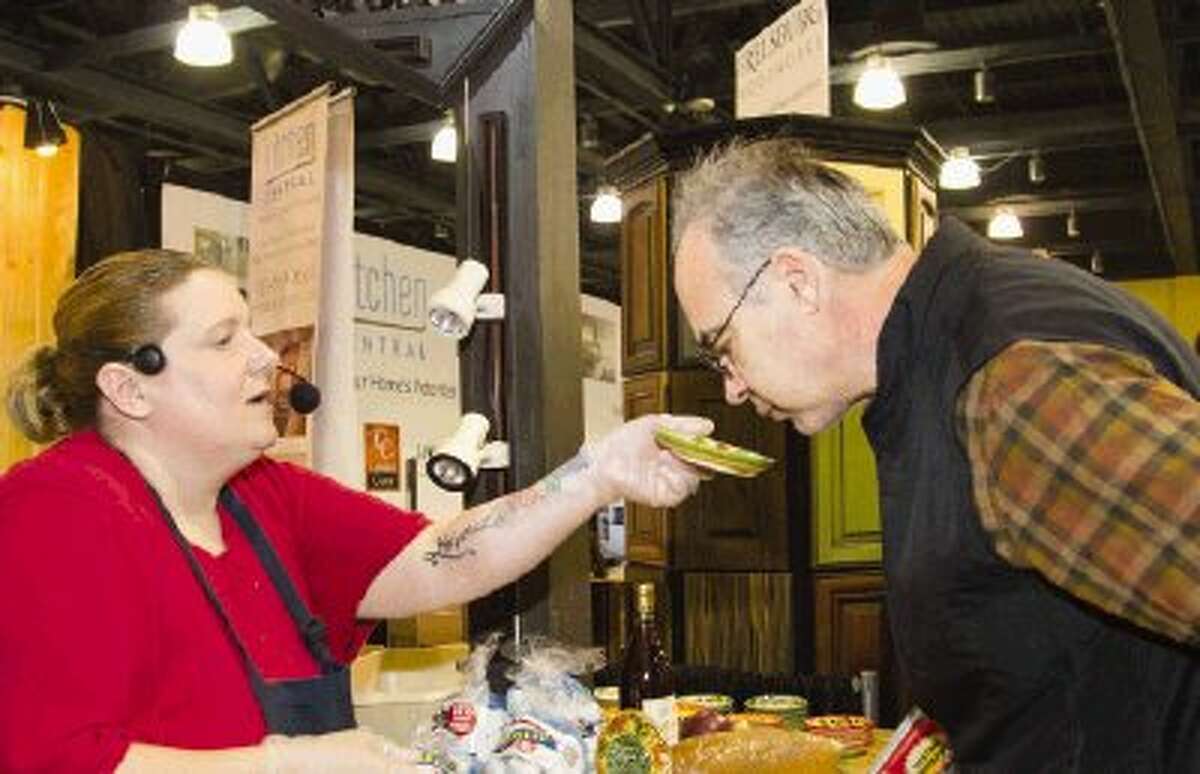 Stacie Hoeppner, aka, The Gourmet Grader, has visitor Tim Byers smell nutmeg during the 12th Annual Spring Home & Garden Show in The Woodlands on Saturday at The Woodlands Waterway Marriott Hotel & Convention Center. To view or purchase this photo and others like it, visit HCNpics.com.