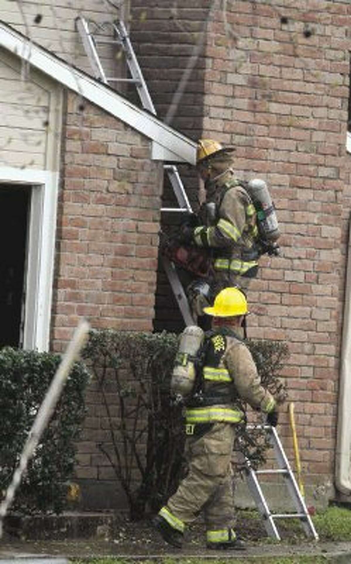 Firefighters work the scene of a fire at Abbey at Conroe Apartments Saturday.