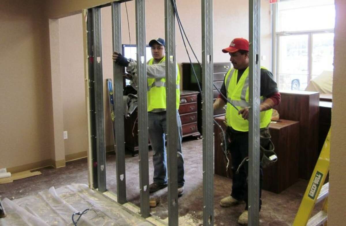 Crews with Montgomery Building Services demolish a wall at Unique Resale to make more room for furniture donations. Unique Resale is located at 1717 N. Frazier in Conroe.