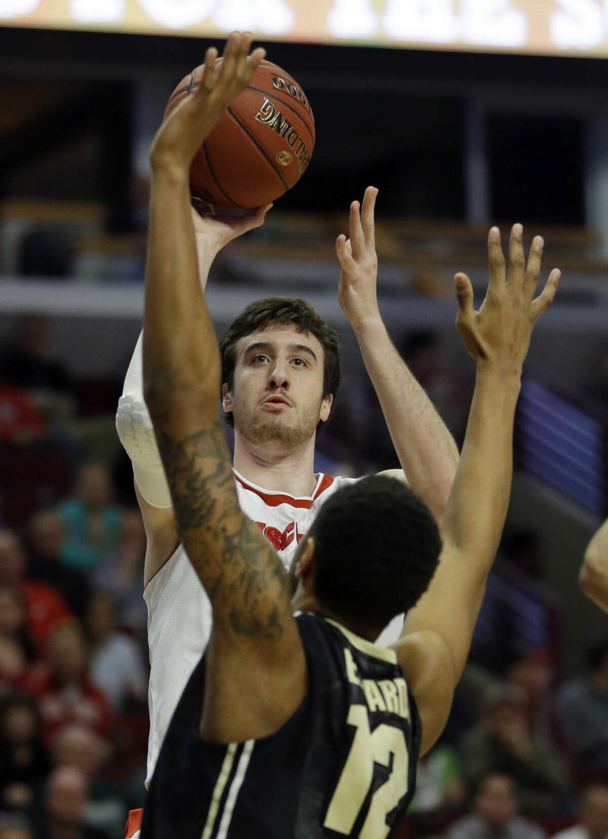Wisconsin's Frank Kaminsky (44) shoots over Purdue's Vince Edwards (12) in the first half of an NCAA college basketball game in the semifinals of the Big Ten Conference tournament in Chicago, Saturday, March 14, 2015. (AP Photo/Michael Conroy)