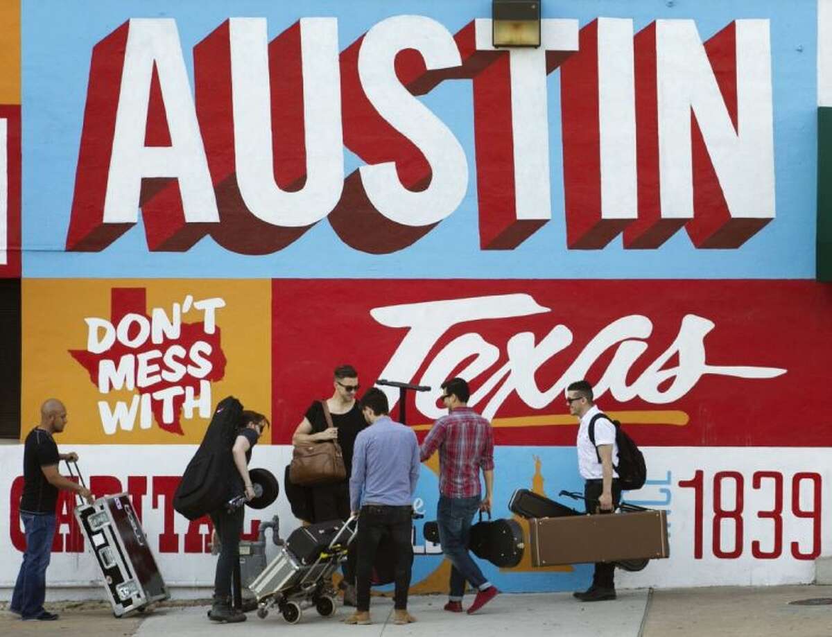 A band is on the move on the corner of Sixth Street and I-35 at South by Southwest in Austin, Texas at last year’s festival in March 2013. Items given away for free at the event are setting airport security alarms and causing reported delays for people leaving Austin, Texas.
