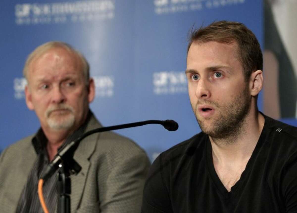 Dallas Stars forward Rich Peverley, right, speaks during a news conference at the University of Texas Southwestern Medical Center on Wednesday in Dallas. Peverley will not play again this season. Also pictured is Stars coach Lindy Ruff.