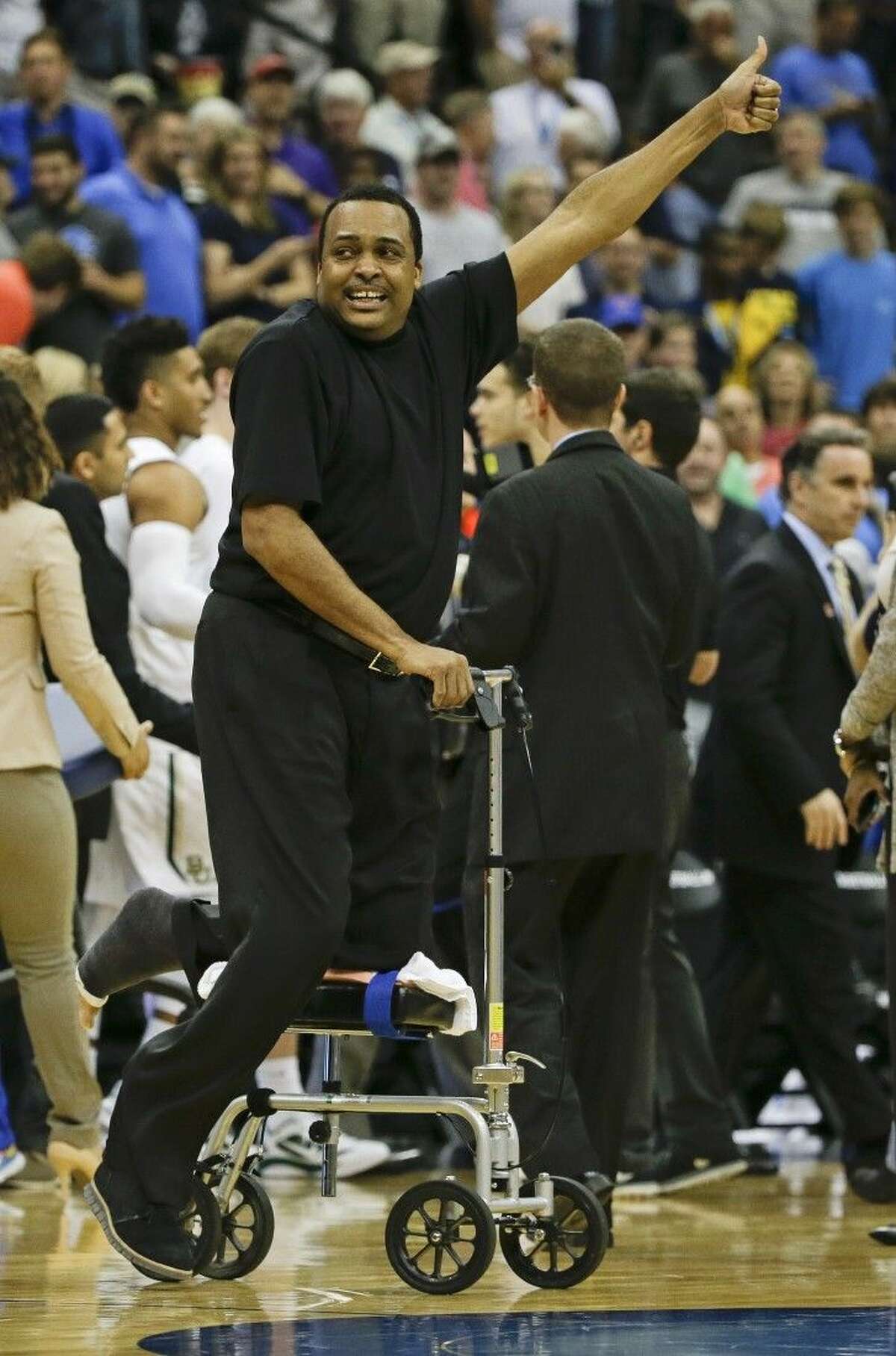 Georgia State head coach Ron Hunter celebrates as he goes on the court after defeating Baylor 57-56 in the secound round Thursday in Jacksonville, Fla.