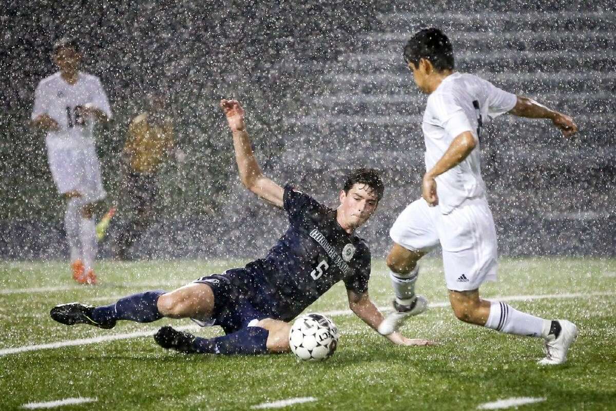 College Park's Stavros Ktenidis (5) dives for the ball in front of Conroe's Fabian Adame (8). Conroe won 2-0. To view more photos from the game, go to HCNPics.com.