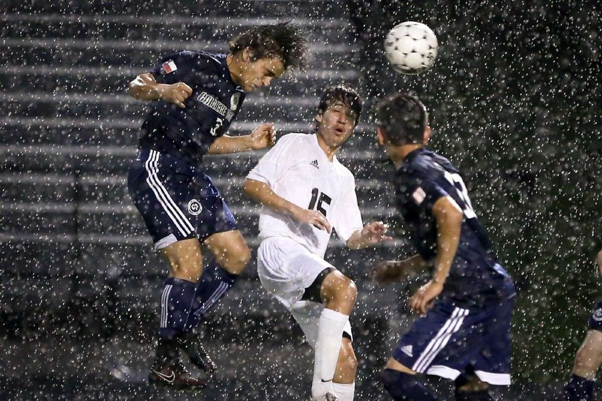 College Park's Christopher Molina (3) and Conroe's Ivan Moctezuma (15) try to head the ball. Conroe won 2-0. To view more photos from the game, go to HCNPics.com.
