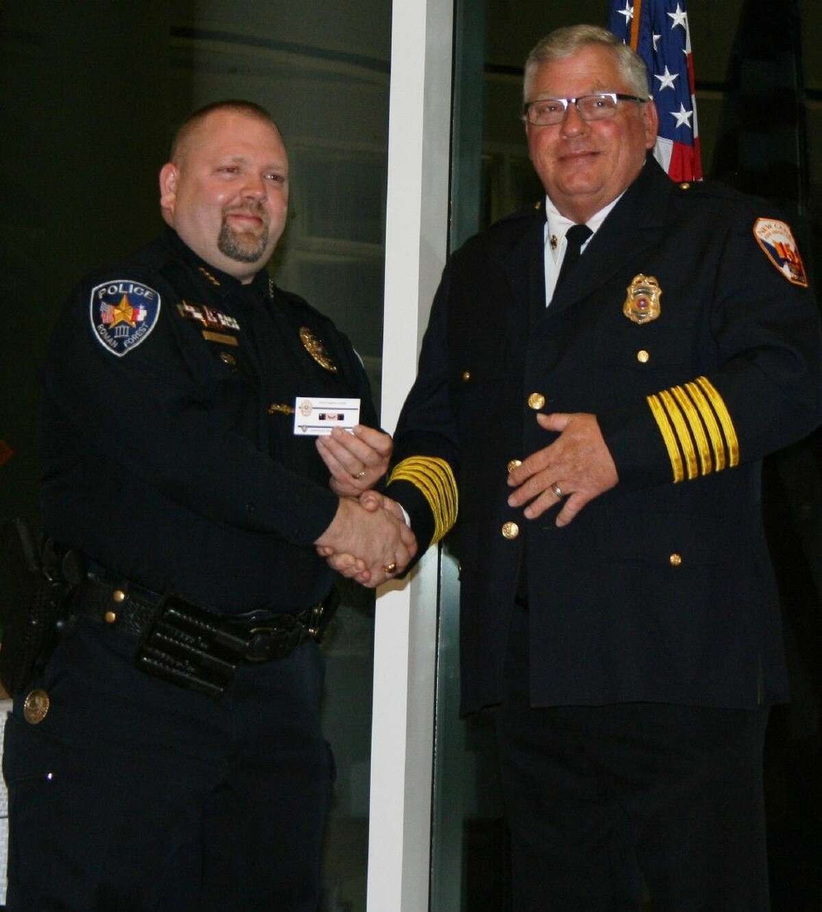 New Caney/Splendora Fire Chief Jeff Taylor extends recognition to Roman Forest Police Chief Stephen Carlisle for his outstanding role in community service during the Roman Forest Law Enforcement Appreciation Dinner on March 16.