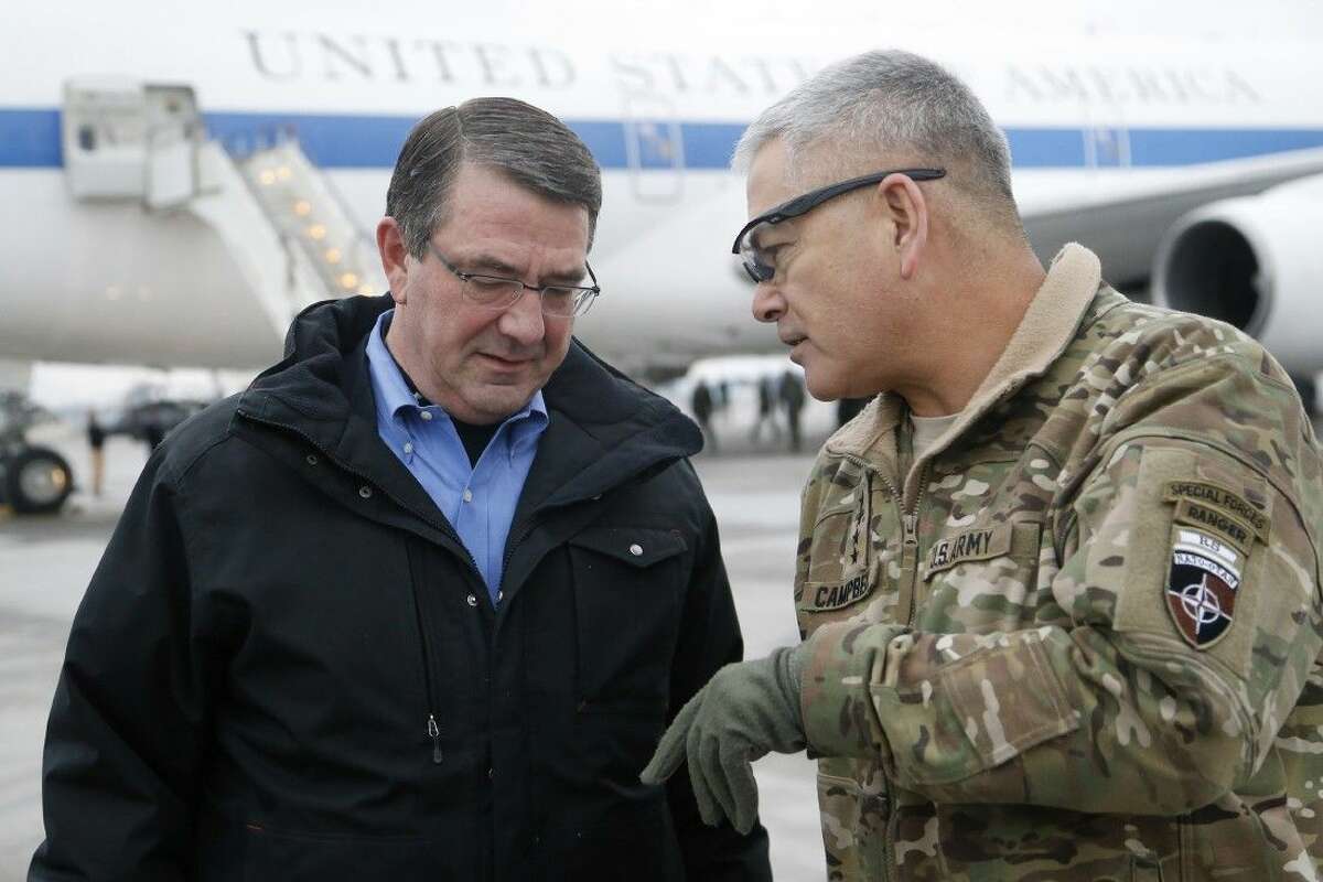 In this Feb. 21, file photo, U.S. Secretary of Defense Ash Carter, left, walks with U.S. Army Gen. John Campbell upon arrival at Hamid Karzai International Airport in Kabul, Afghanistan. The pace of U.S. troop withdrawals from Afghanistan will headline Afghan President Ashraf Ghani’s visit to Washington.