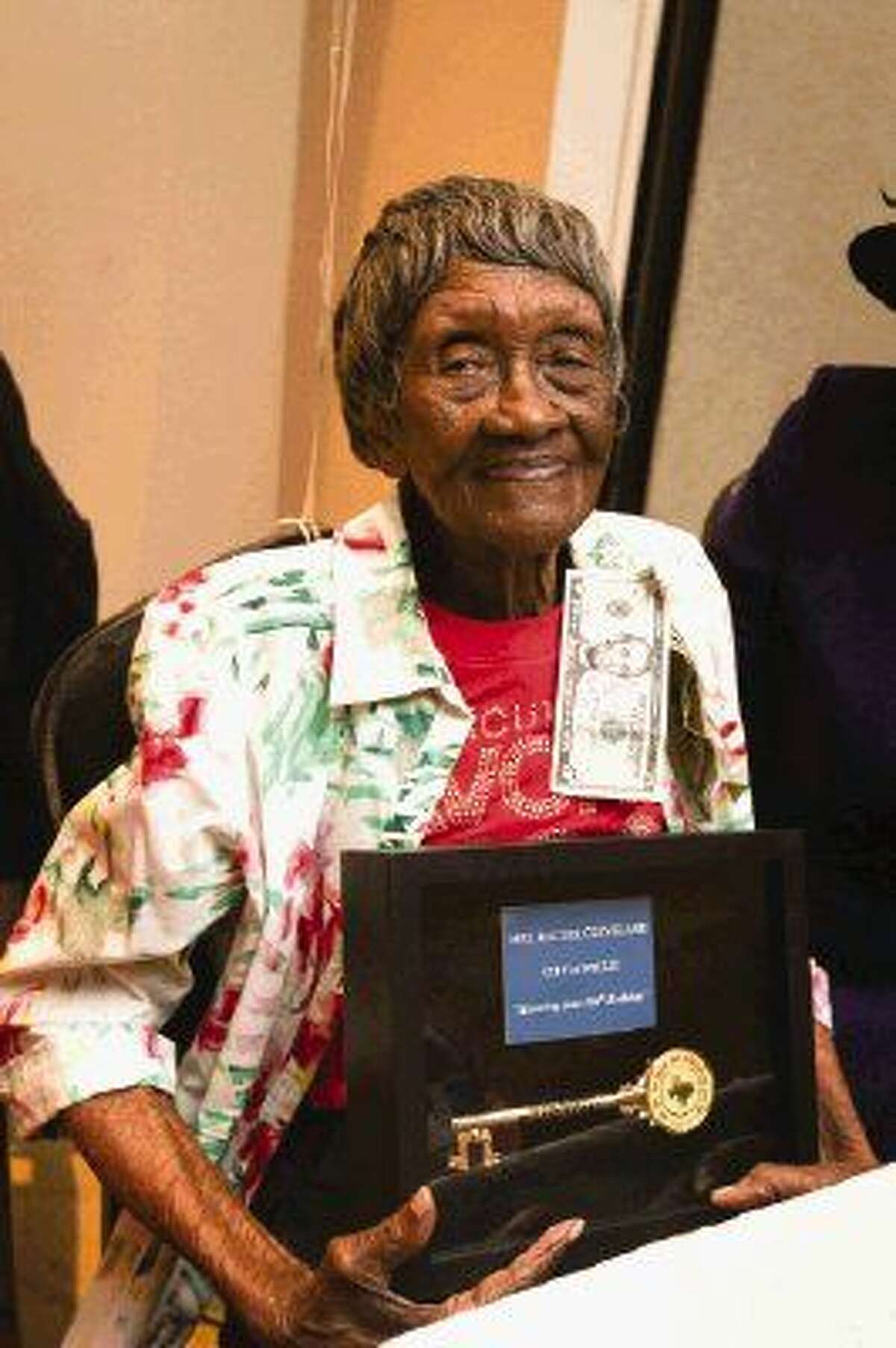 Willis resident Rachel Cleveland celebrates turning 100 years old by receiving a key to the city from Mayor Leonard Reed on Sunday at the North Montgomery Community Center.
