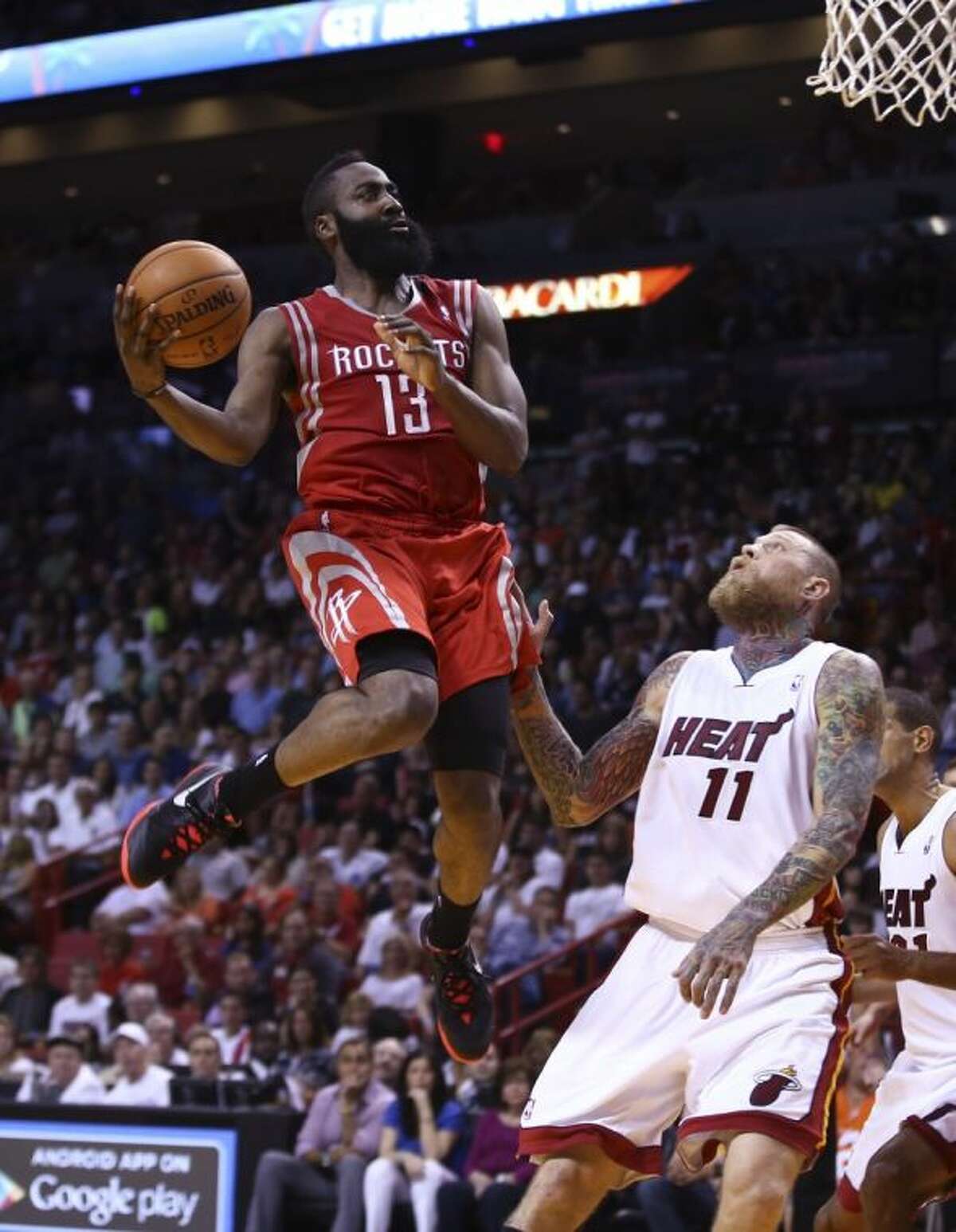 Houston Rockets guard James Harden shoots over the Miami Heat's Chris Andersen in the second half. The Heat won 113-104.