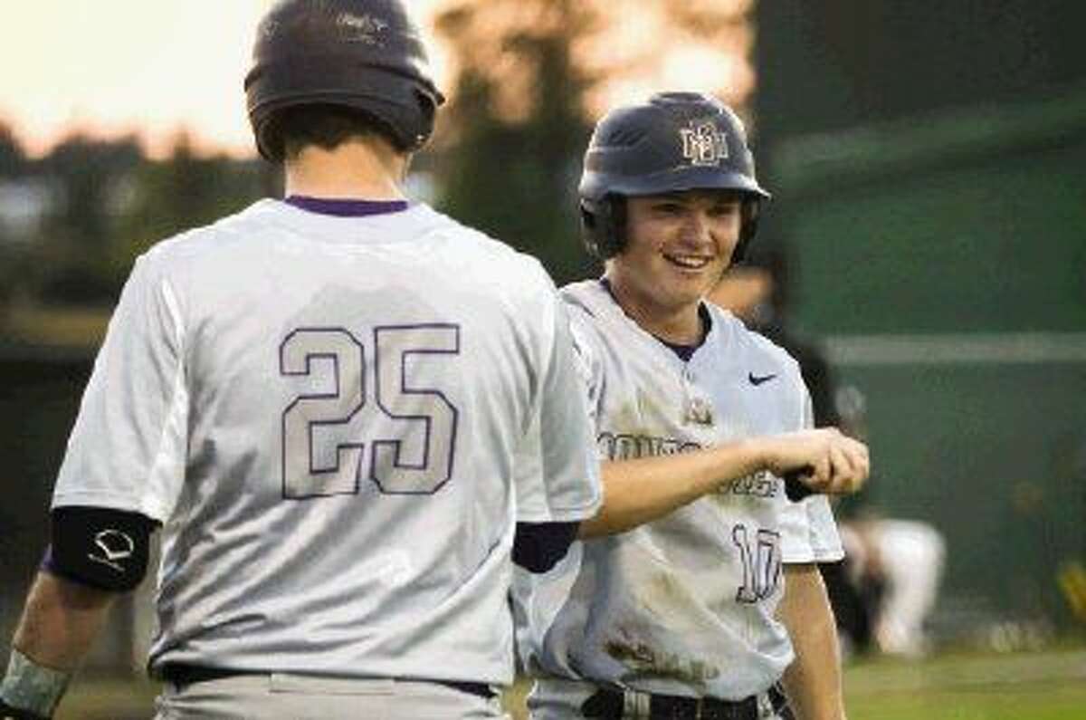 Montgomery's Jake Rice (10) high fives a teammate after scoring a run against Spring on Tuesday at Spring High School.