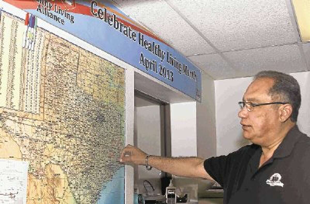Willis City Manager Hector Forestier shows a Texas map where city workers updated their progress in the 2013 challenge to walk across Texas to promote healthy living in celebration of healthy living month in April. Workers were divided into teams and tasked to use the devices to keep track of their steps to see who could collectively walk across Texas the most in April. The City of Willis and Willis Police Department will participate in the Walk Across Texas challenge again in 2014.