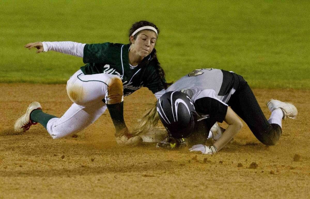 The Woodlands shortstop Abby Jones tags out Conroe's Katie Henshaw trying to steal second during a District 16-6A softball game Wednesday.
