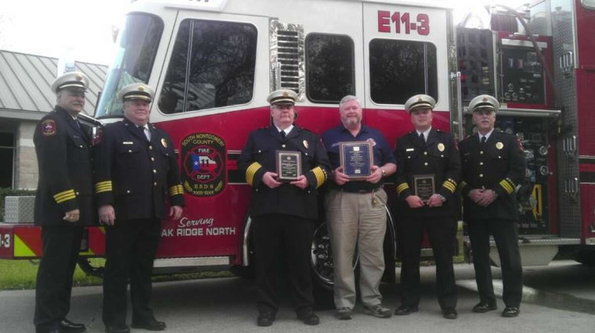 Members of the South Montgomery County Fire Department proudly display a plauqe commemorating their Class 1 Insurance Services Office rating following a presentation at Oak Ridge North City Hall Wednesday evening. From left to right: Cpt. John Bradley; Assistant Fire Chief Michael Johnson; Fire Chief Robert Hudson; Commissioner James Kelly; Deputy Chief Clint Cooke; and Deputy Chief Tommy Erickson.