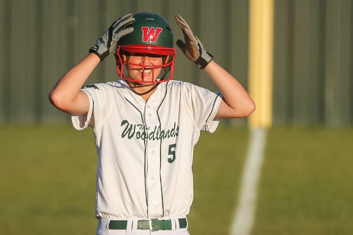 The Woodlands' Mattison Holt (5) smiles after driving in two runs on Friday at The Woodlands High School.