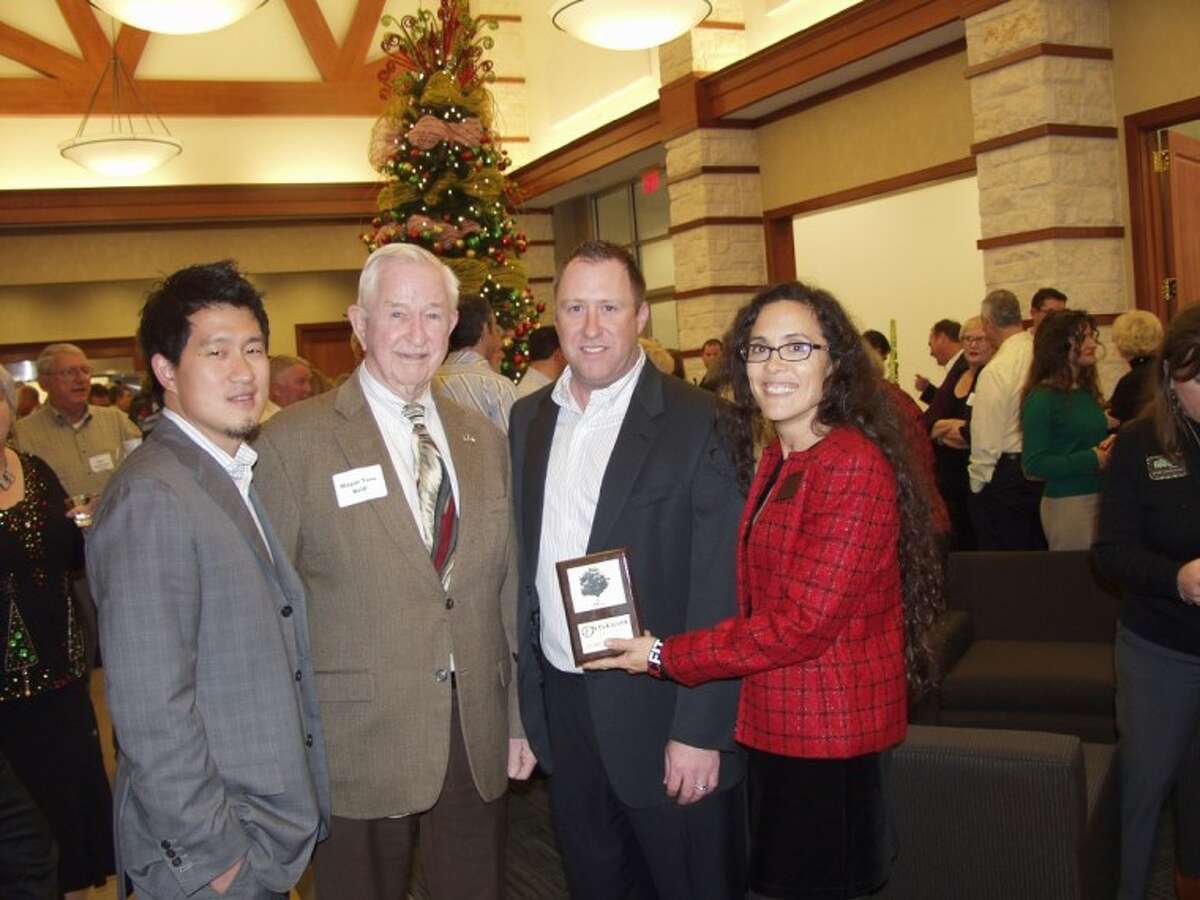 Sherwin Sun and Fay Watson of Keep Pearland Beautiful presented the bank with a plaque commemorating their recent contribution for membership and the adoption of Province Village Drive. Also pictured are Mayor Tom Reid and Branch Manager Sean Murphy.