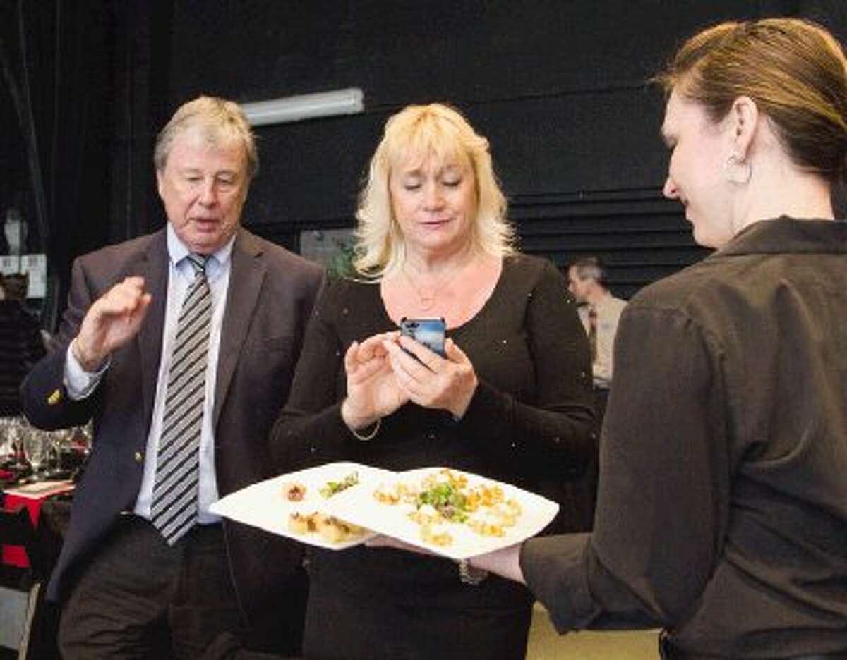 Jon Samuelson and Lelia Stone deny appetizers during the annual Wine Dinner & Auction at the Cynthia Woods Mitchell Pavilion on the Main Stage in The Woodlands Sunday. The event profited The Pavilion’s education programs and Partners Fine Arts Scholarship Fund.