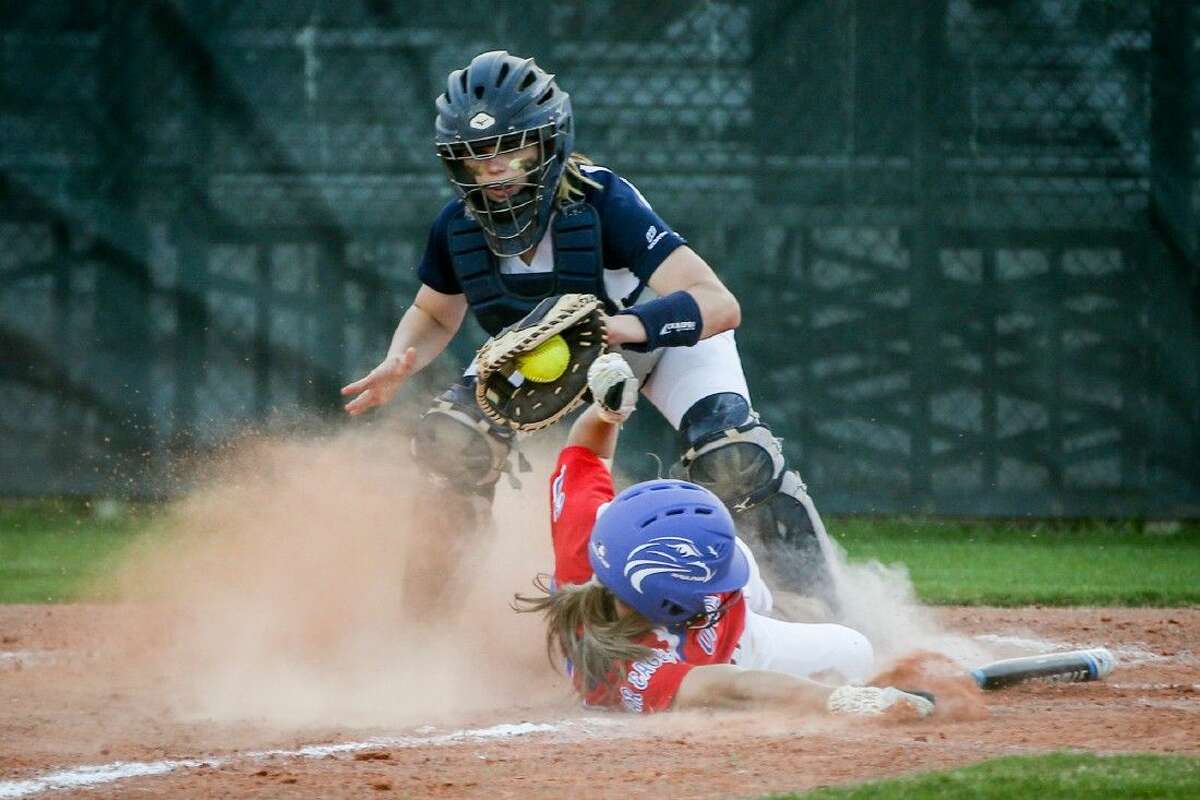 College Park’s Kyristen Stockman (9) tags Oak Ridge’s Cheyenne Cavanaugh (2) at home plate during a high school softball game on Monday at College Park High School. To view more photos from the game, go to HCNPics.com.