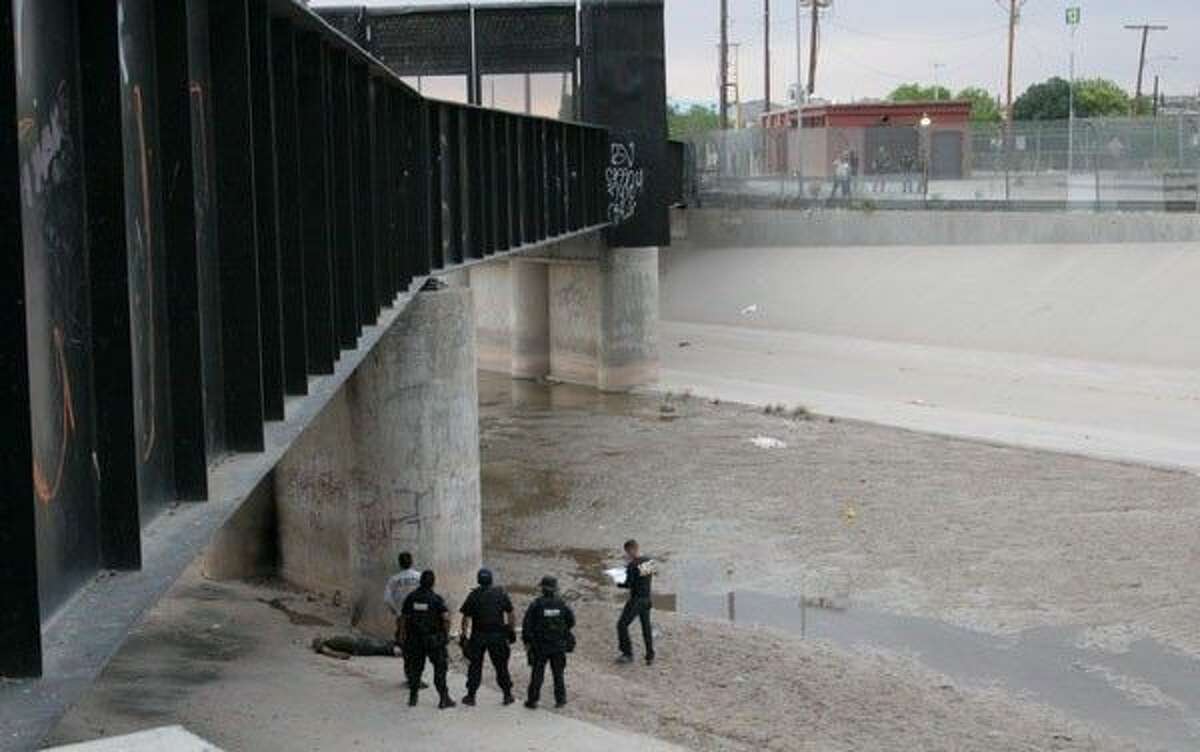 U.S. Border Patrol looks on at a scene where a Mexican teen was shot by an agent in 2010.