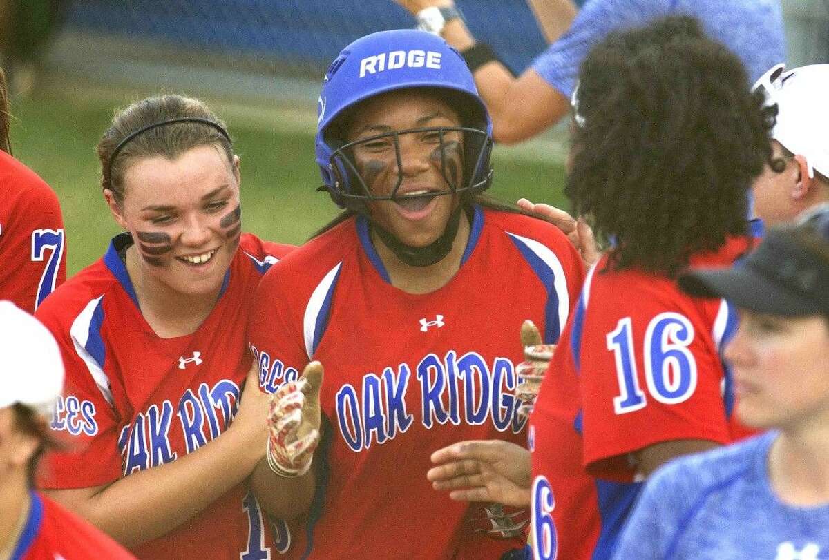 Oak Ridge’s Aiyana Freeney, center, celebrates after hitting a three-run home run in the second inning of a District 16-6A softball game Tuesday. Go to HCNpics.com to purchase this photo and others like it.
