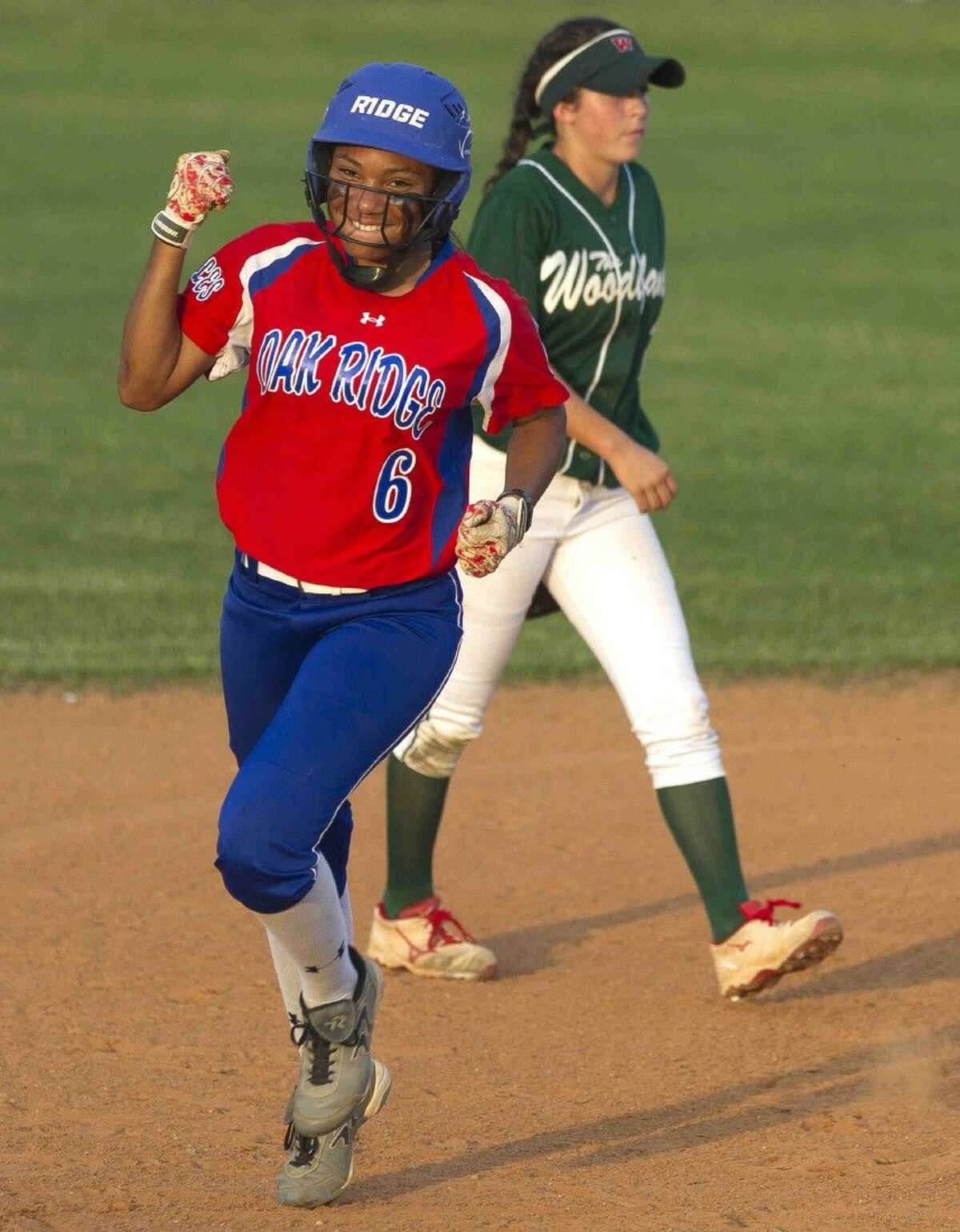Oak Ridge’s Aiyana Freeney celebrates after hitting a three-run home run in the second inning of a District 16-6A softball game Tuesday. Go to HCNpics.com to purchase this photo and others like it.