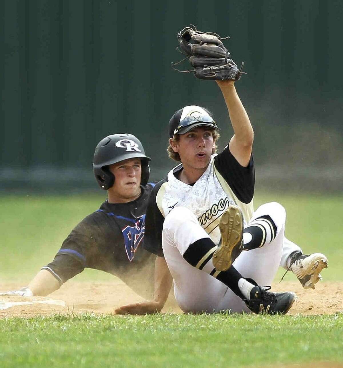 Conroe second baseman Dawson Shibley holds up his glove as he and Oak Ridge base runner Tyler Hicks look for a call during a District 16-6A baseball game Friday. Go to HCNpics.com to purchase this photo and others like it.
