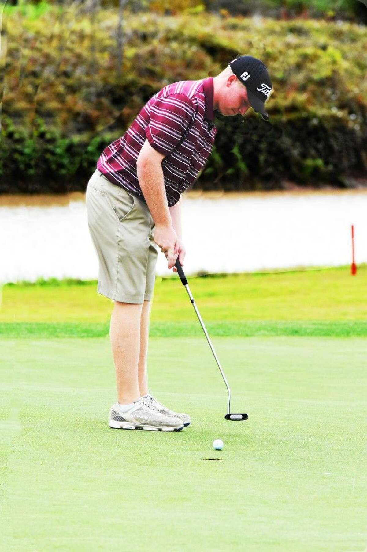 Magnolia West’s Jake Wade putts during the District 19-5A championship Wednesday at River Ridge Golf Course.