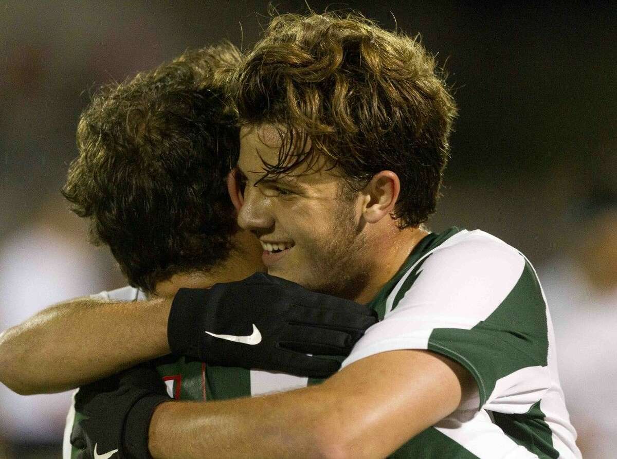 The Woodlands midfielder Nicholas Pekel hugs Keno Tamez after his assist led to Tamez's goal in the second period of a Region II-6A area round playoff game at A&M Consolidated High School Friday in College Station. The Woodlands defeated Round Rock McNeil 2-1. Go to HCNpics.com to purchase this photo and others like it. \rr5