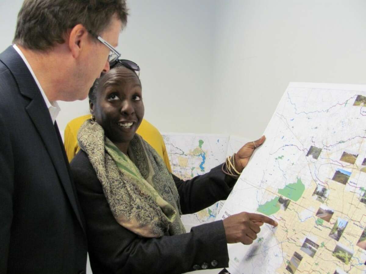 Sakina Lanig with state Sen. Rodney Ellis' office discusses the Bayou Greenways Initiative with Houston Parks Board member Michael Skelly. The board is purchasing land to fulfill a 100-year-old vision to create parks and trails along the region's bayou system.