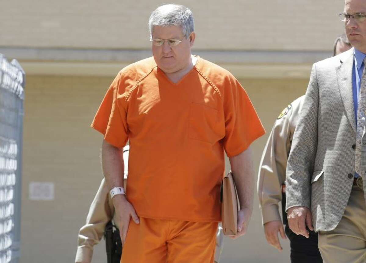 Bernie Tiede is led into the Panola County court house by law enforcement officials in Carthage, Texas, Tuesday, May 6, 2014. The former mortician serving a life sentence for the death of a rich East Texas woman could soon go free with the agreement of the district attorney who prosecuted him. Tiede, whose case inspired the Matthew McConaughey movie “Bernie,” is expected in court in Carthage, Texas.