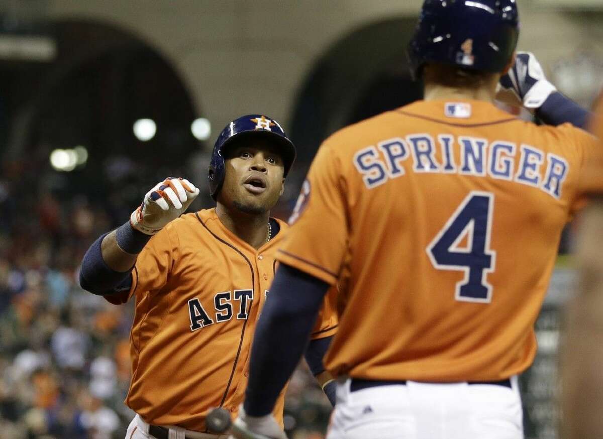 Houston Astros’ Luis Valbuena, left, celebrates with George Springer after hitting a home run against the Toronto Blue Jays on Friday in Houston.
