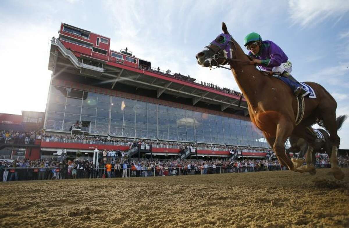 California Chrome, ridden by jockey Victor Espinoza, won the 139th Preakness Stakes in Baltimore.