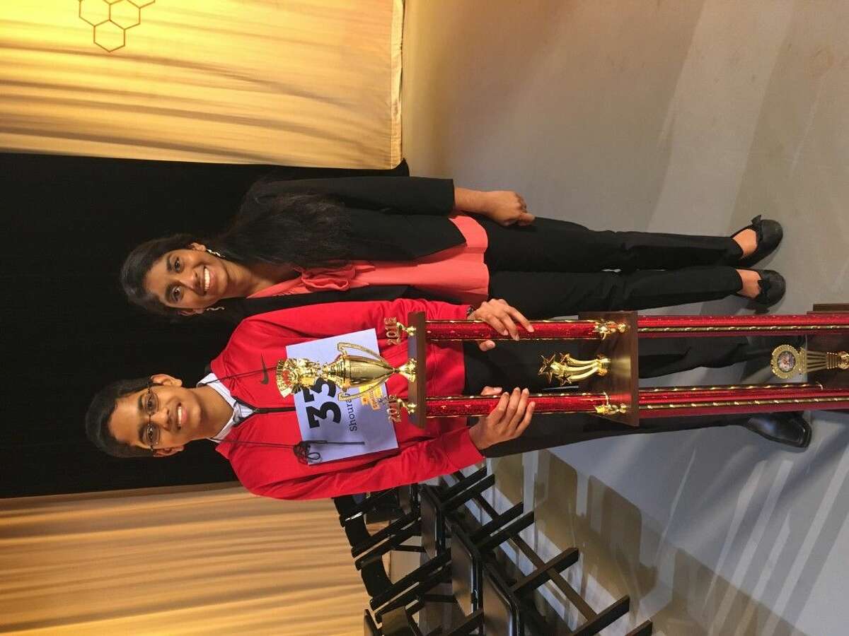 Shourav Dasari, a McCullough Junior High seventh-grader, poses with his trophy after winning the 2016 Houston Public Media Spelling Bee - the second largest in the nation. Next to him is his sister Shobha Dasari, a three-time winner of the Houston event.