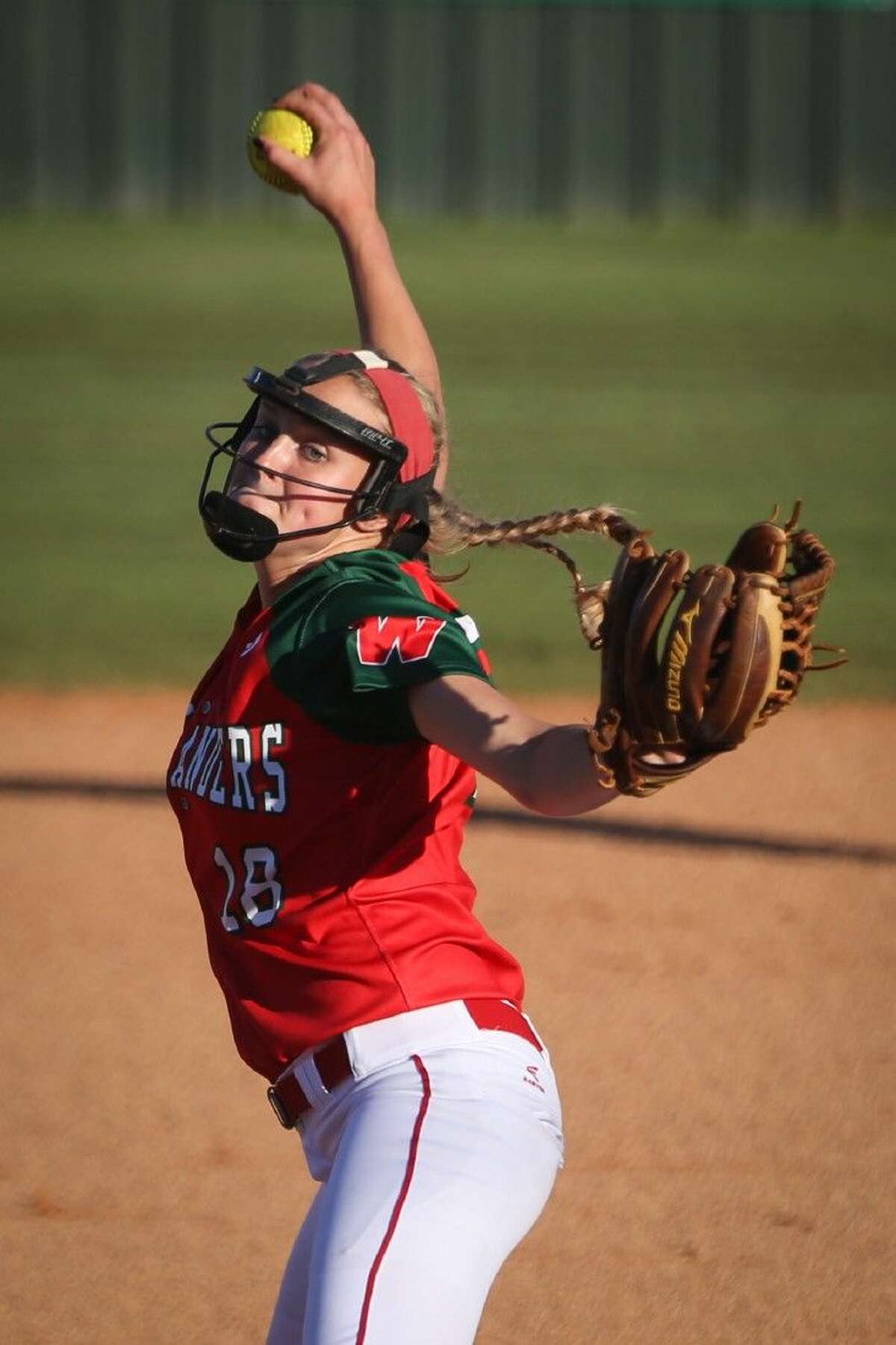 The Woodlands’ Emily Langkamp (18) throws a pitch on Friday at The Woodlands High School. To view more photos from the game, go to HCNPics.com.