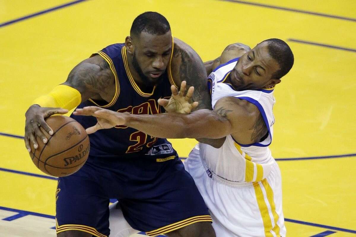 Cleveland Cavaliers forward LeBron James, left, is guarded by Golden State Warriors forward Andre Iguodala during the second half of Game 2 of the NBA Finals in Oakland, Calif., Sunday.