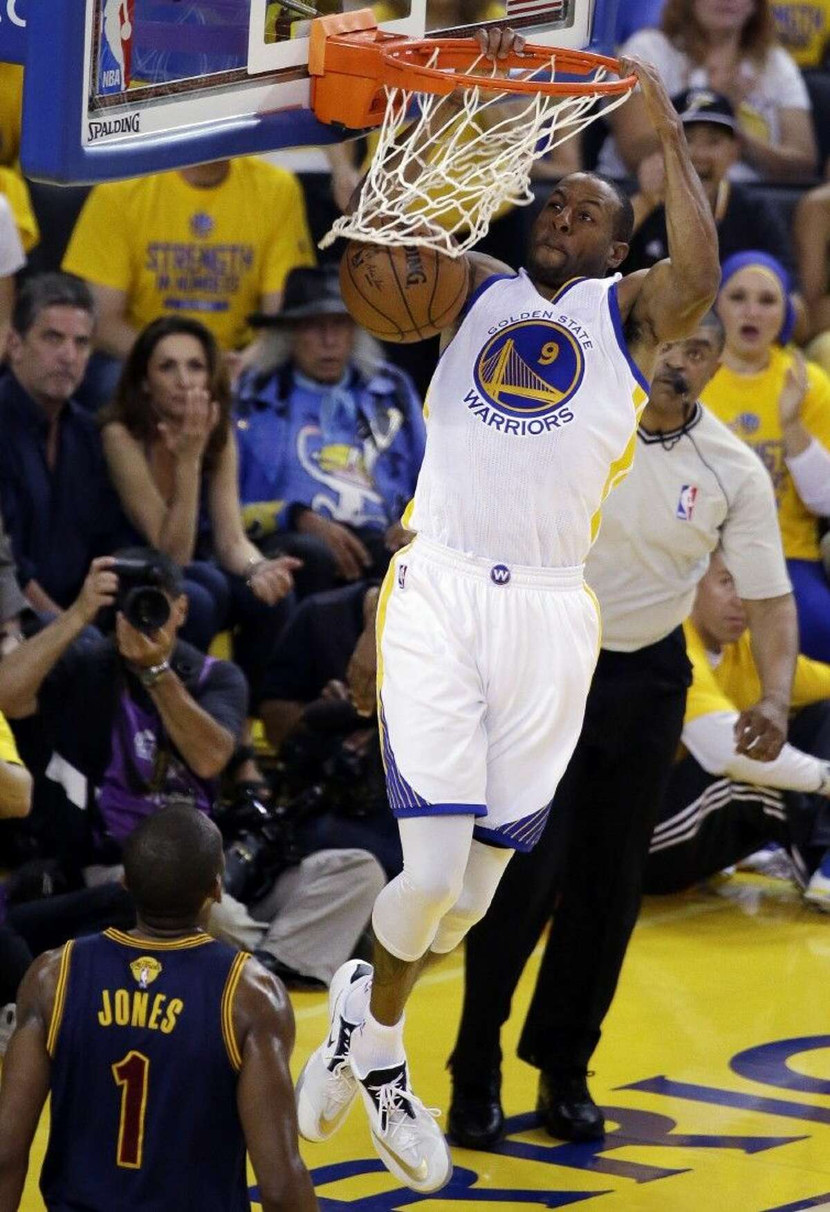 Golden State Warriors forward Andre Iguodala (9) dunks against Cleveland Cavaliers forward James Jones (1) during the first half.