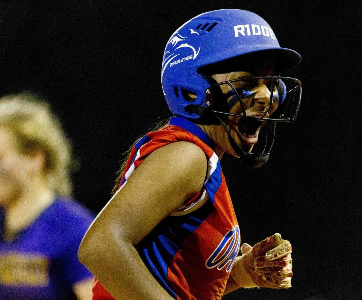 Aiyana Freeney, of Oak Ridge, celebrates after hitting a triple in the bottom of the seventh innning of a Region II-6A bi-district softball playoff game Thursday at Oak Ridge High School. Freeney scored the go-ahead run off a wild pitch by pitcher Katy Simon, of Montgomery, to give the Lady War Eagles a 4-3 win over the Lady Bears.