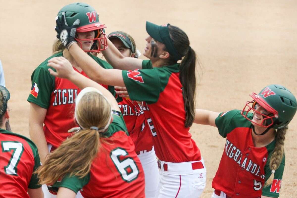 The Woodlands teammates celebrate after Amanda Hurran hit a two-run homer during the high school softball game against Klein Oak on Friday at Tomball High School. To view more photos from the game, go to HCNPics.com.