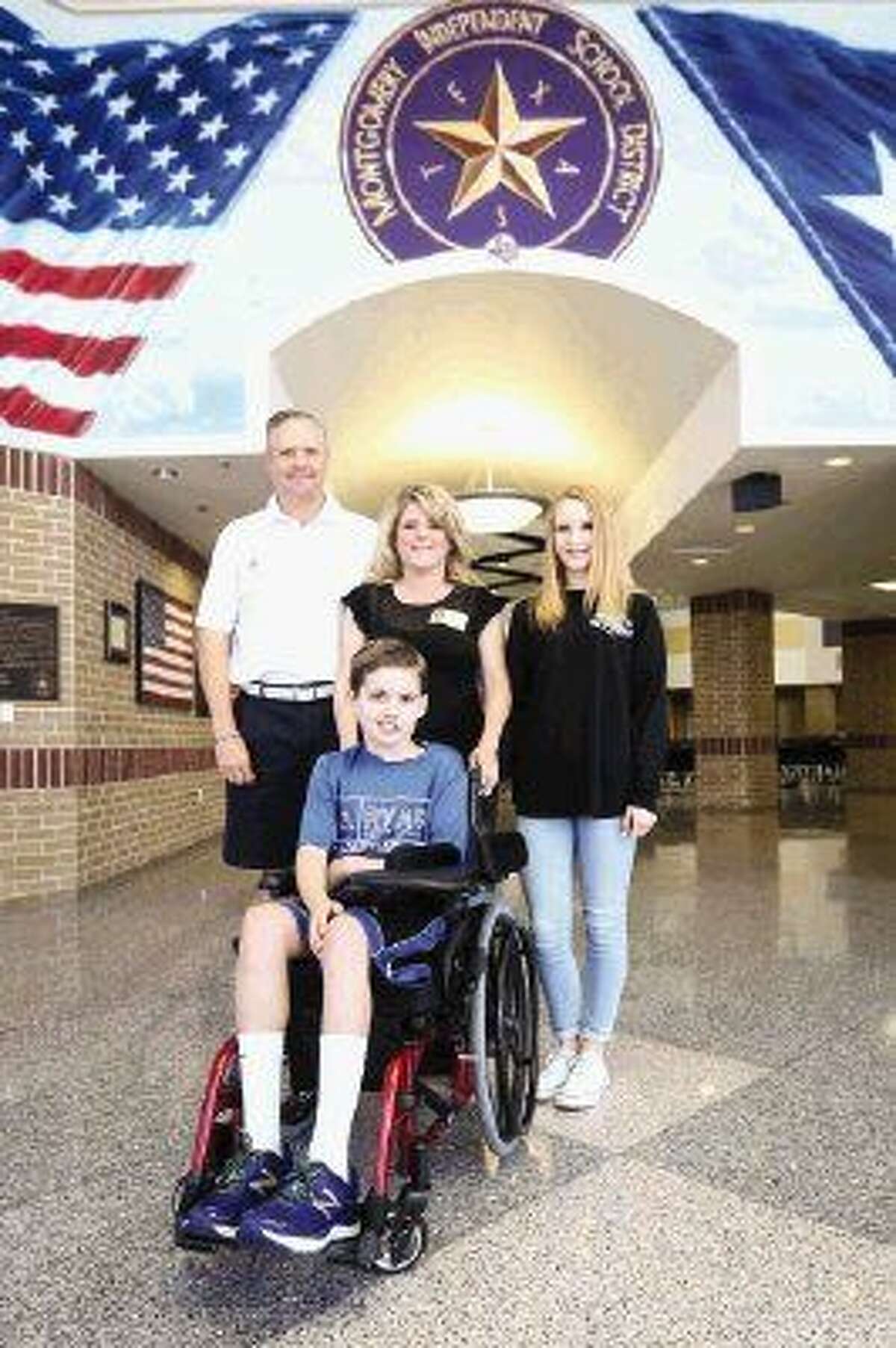 Ryan Logan and his family pose for a portrait on Friday at Montgomery Junior High School.