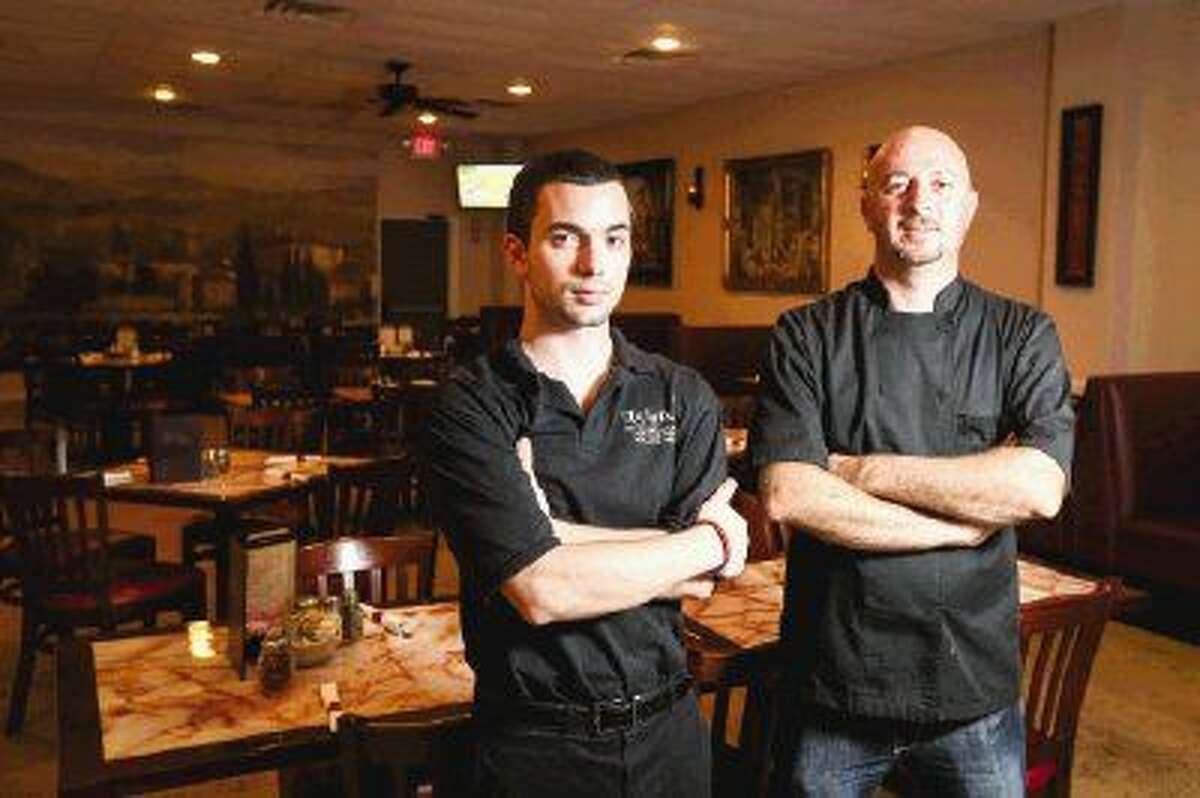 Owner Marko Rezart poses for a portrait with head server Mark Lozelle on Tuesday at Luigi's Italian Restaurant in Conroe. Luigi’s serves southern Italian food cooked to order, according to Rezart.