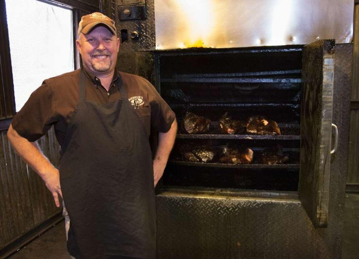 Darin McKenzie, co-founder of McKenzie’s Barbeque and Burgers & Fries, is pictured with some of the famous McKenzie’s Barbeque.
