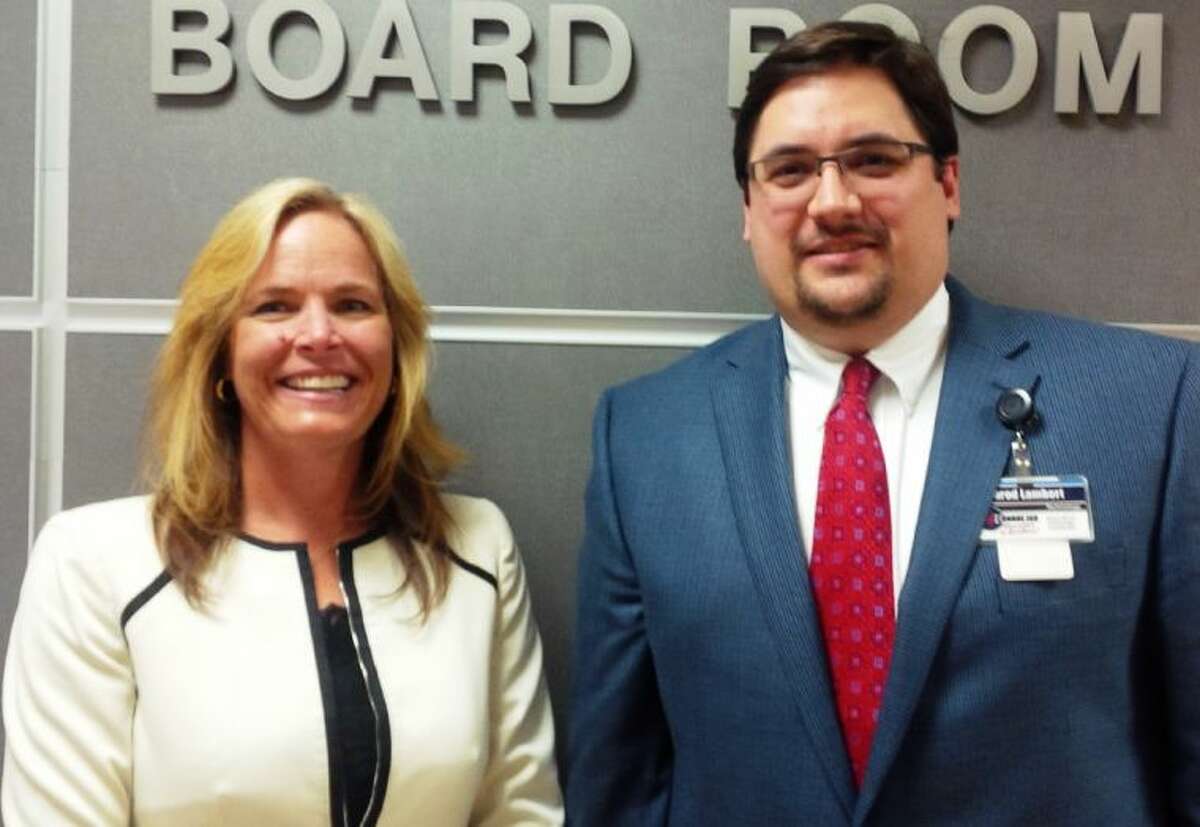 Conroe ISD Education Foundation Executive Director Maris Blair poses at the Conroe ISD Board Room with Jarod Lambert. An employee of Conroe ISD, Lambert received one of the Foundation’s 2014 Educator Scholarships to help obtain his doctorate degree.