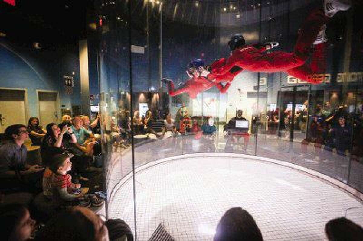 Friends, family and supporters watch as participants in the Wheels with Wings Foundation charity get an opportunity to try indoor skydiving on Tuesday at iFly Houston-Woodlands Indoor Skydiving.