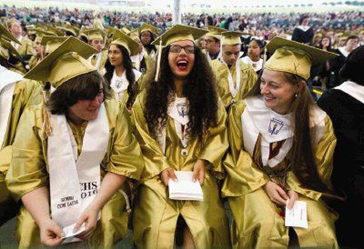 Glenna Hirvela, Natalie Holmes and Claudia Helbig share a laugh before the start of Conroe High School’s graduation ceremony at the Cynthia Woods Mitchell Pavilion Thursday. Go to HCNpics.com to purchase this photo and others like it.