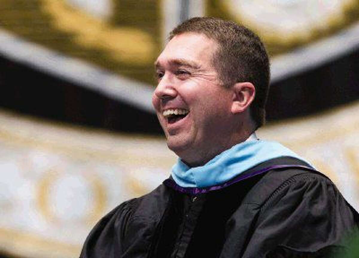 Conroe High School Principal Mark Weatherly laughs as Gage Hallbauer addresses students, teachers and families during Conroe High School’s graduation ceremony at the Cynthia Woods Mitchell Pavilion Thursday. Go to HCNpics.com to purchase this photo and others like it.