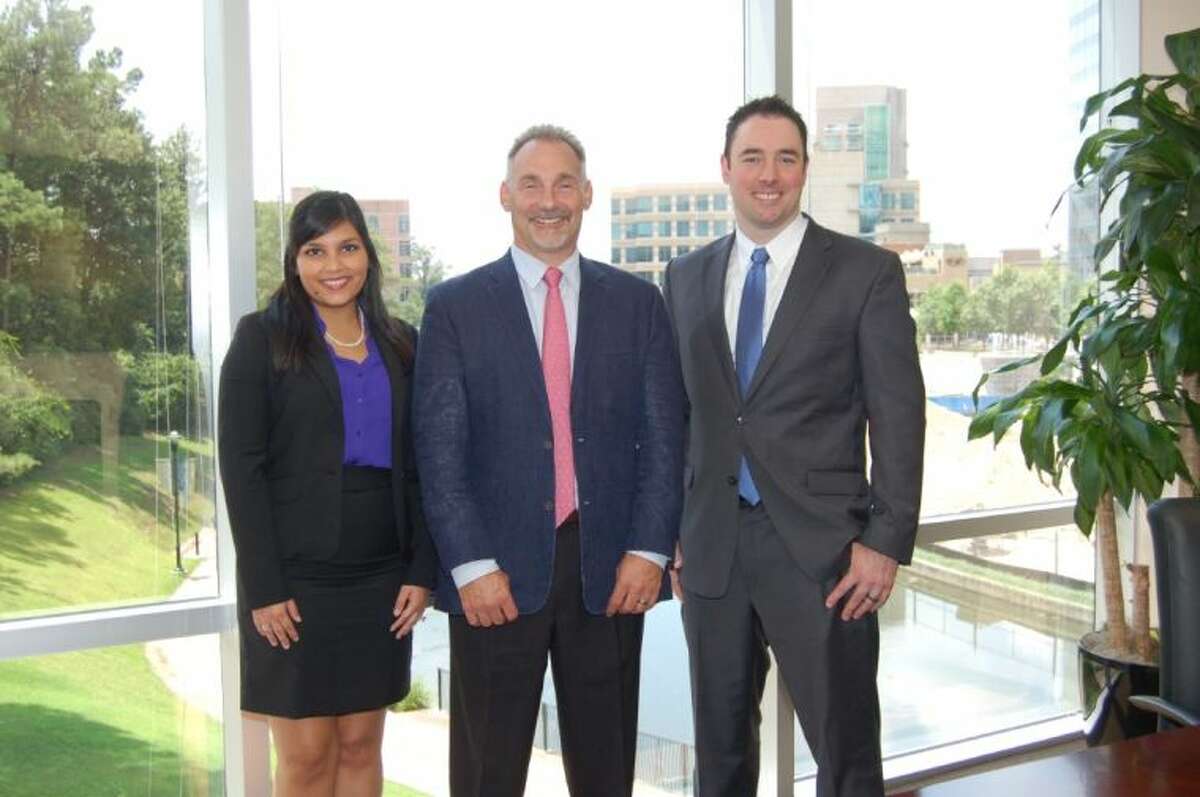 Bret L. Strong, center, founder and managing shareholder of The Strong Firm, welcomes Jeremy Clarke, right, as a law clerk and Erica Reyes as summer intern.
