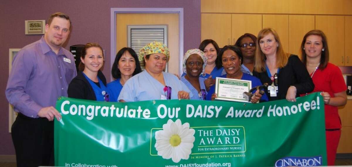 Daisy honoree Gweneth Tanner (holding certificate) and the 3 East team celebrate Tanner’s award.