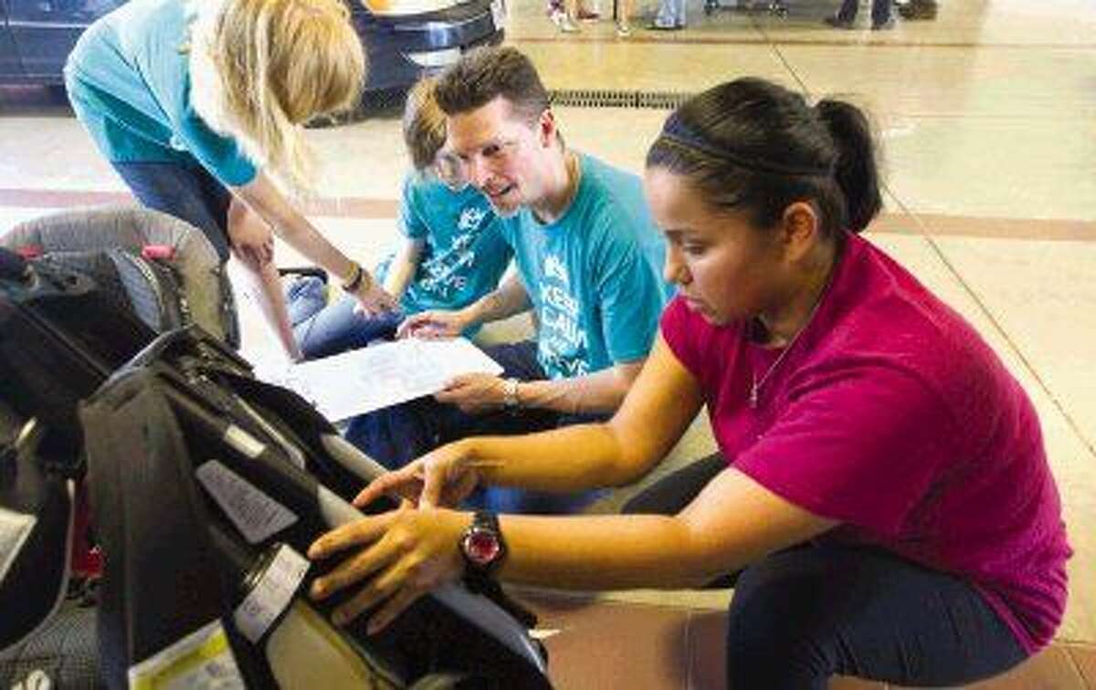 Checking car seats Safe Kids of Houston performs safety inspections
