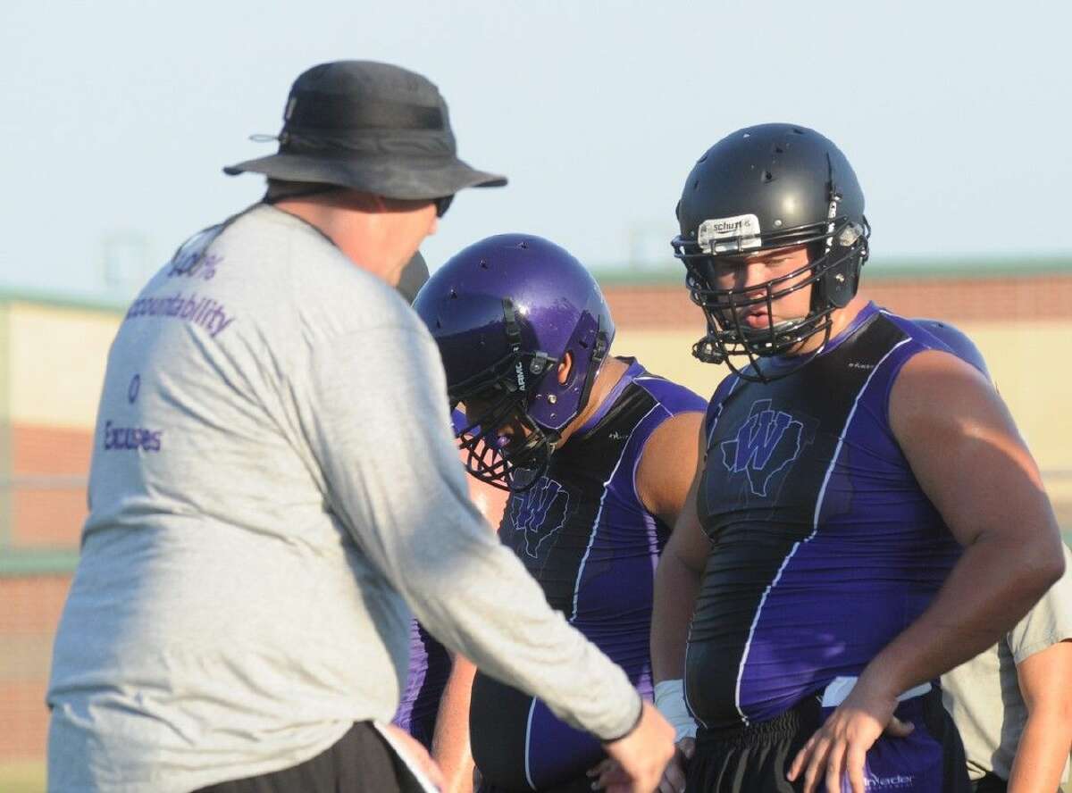 Willis offensive linemen get instructions during practice at Willis High School on Monday.