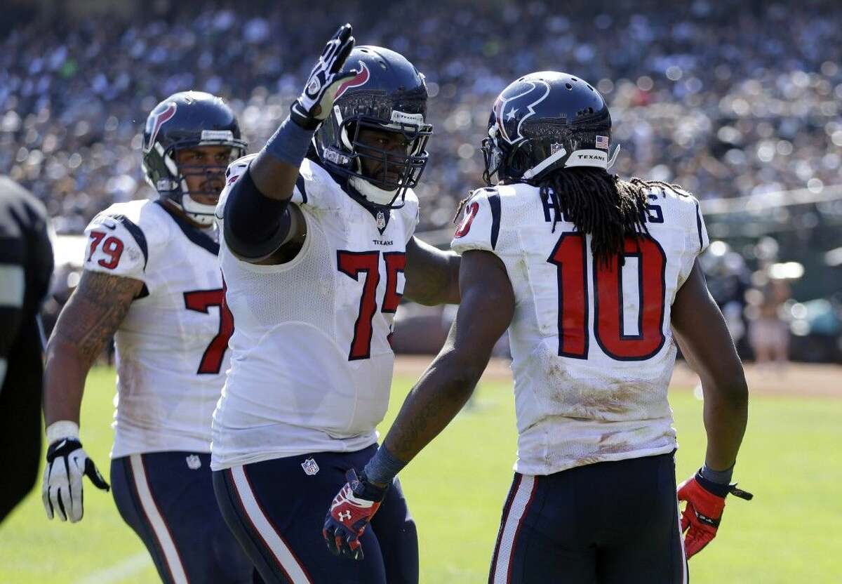 AP photoHouston Texans offensive linemen Derek Newton and Brandon Brooks (79) congratulate wide receiver DeAndre Hopkins (10) after Hopkins caught a 12-yard pass from Ryan Fitzpatrick for a touchdown in the third quarter against the Oakland Raiders on Sunday in Oakland, Calif.